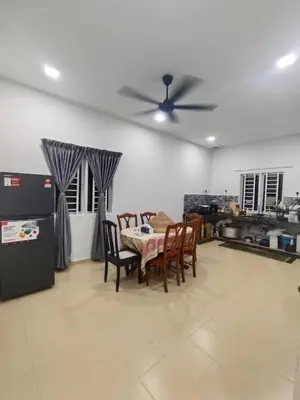 a living room with a table and chairs and a ceiling fan at Rumah Pak Syed in Ipoh