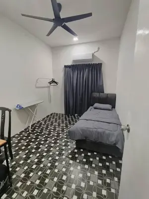 a bedroom with a bed and a ceiling fan at Rumah Pak Syed in Ipoh