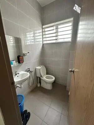 a bathroom with a toilet and a sink at Nameera Stay Bandar Universiti Seri Iskandar in Seri Iskandar