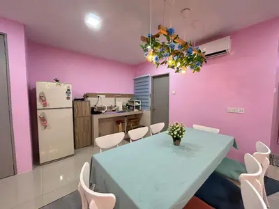 a dining room with a blue table and pink walls at Sky Garden Ipoh Comfortable Homestay 6-7pax SY27 in Chemor
