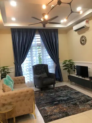 a living room with a couch and a chair and a television at DQis Nest Casa Apartment in Chemor