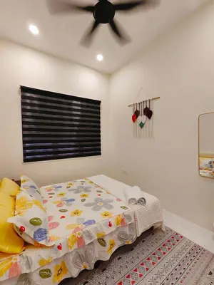 a bedroom with a bed and a ceiling fan at Arjuna Homestay - Batu Gajah in Batu Gajah