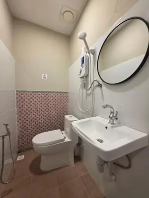 a bathroom with a toilet and a sink and a mirror at Burma Home at Jalan Burma Georgetown Penang in George Town