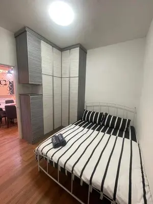 a bedroom with a bed with a backpack on it at Syahoney Homestay 2 with NETFLIX in Tanah Rata