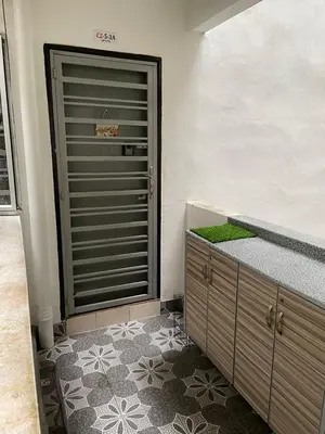a bathroom with a closet and a door with green moss at Syahoney Homestay 2 with NETFLIX in Tanah Rata