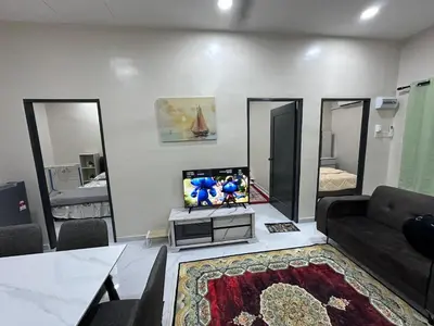 a living room with a couch and a tv at Anjang Pat Kesang Laut Homestay in Gua Sai