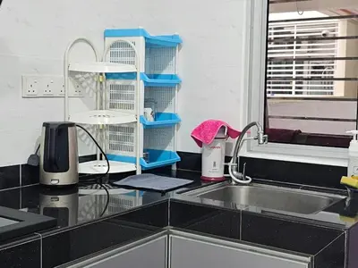 a kitchen counter top with a sink and a kitchen counter top with a sink at Sekinchan Family-style XL Size Homestay in Sekincan