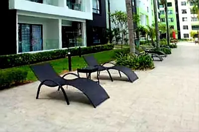 a row of black chairs sitting on a sidewalk at Ipoh Manhattan Waterpark 3BR Suite by City Home Empire MHB509 in Ipoh