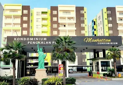 a sign with a statue in front of a building at Ipoh Manhattan Waterpark 3BR Suite by City Home Empire MHB509 in Ipoh