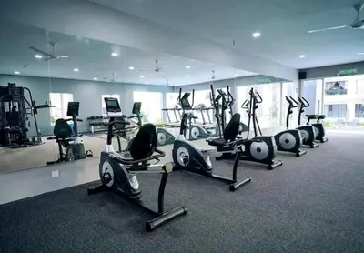 a gym with a row of treadmills and exercise bikes at Ipoh Manhattan Waterpark 3BR Suite by City Home Empire MHB509 in Ipoh