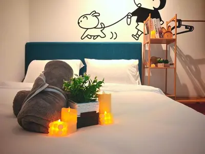 a bedroom with a bed with a blanket and lights on it at Ipoh Manhattan Waterpark 3BR 8Pax Suite by City Home Empire MHA304 in Ipoh