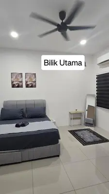 a bedroom with a bed and a ceiling fan at Dee Intan Homestay, Ipoh - Malay Only in Ipoh