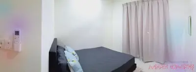a bedroom with a bed and a window with curtains at Nausha Homestay Mus-lim ONLY in Kulim