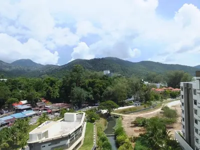a view of a city with mountains in the background at Ferringhi Luxury Suite @ By The Sea in Batu Ferringhi