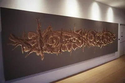 a large wooden art on a wall in a room at Ferringhi Luxury Suite @ By The Sea in Batu Ferringhi