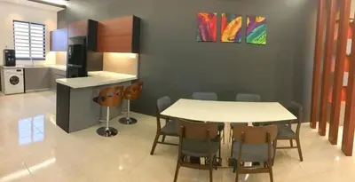 a kitchen and dining room with a table and chairs at Homestay sweet dream in Gua Sai
