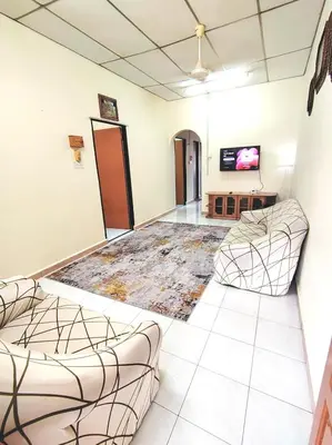 a waiting room with two chairs and a flat screen tv at D'Manjung Samudera Baru HomeSTAY in Seri Manjung