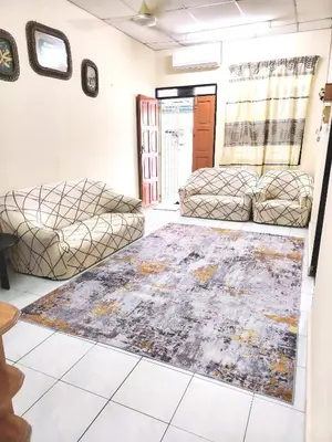 a living room with two couches and a rug at D'Manjung Samudera Baru HomeSTAY in Seri Manjung