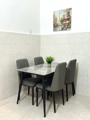 a dining room table and chairs with a plant on it at Vintage-Living 2Storey Haus12Pax in Simpang Ampat