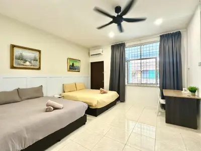 a bedroom with two beds and a ceiling fan at Vintage-Living 2Storey Haus12Pax in Simpang Ampat