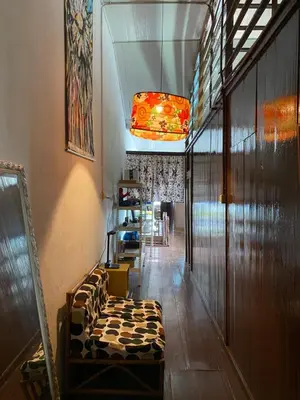 a hallway with a couch in a room at Bitterswiit Ladies Hostel in George Town