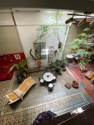 a living room with a table and some plants at Bitterswiit Ladies Hostel in George Town