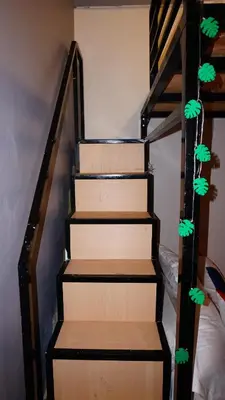 a set of stairs with green leaves on them at Cozy Loft Bed Mini Studio Golf View in Gua Sai
