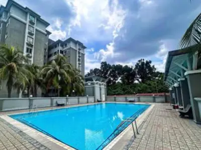 a large blue swimming pool with palm trees and buildings at Cozy Loft Bed Mini Studio Golf View in Gua Sai