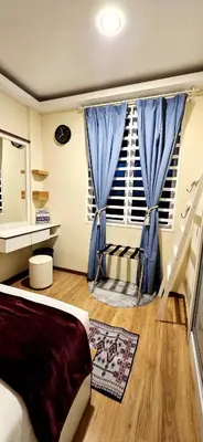 a bedroom with a blue curtain and a window at #MyHighlandGetaway at OmniCassia Cameron Highlands in Cameron Highlands