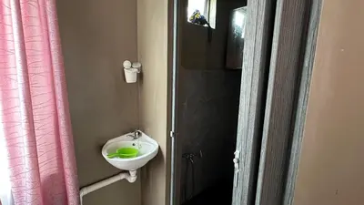 a bathroom with a sink and a green bowl at Serene Villa in Kepala Batas