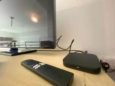 a remote control sitting on a table next to a tv at Minimalist Balcony Duplex w Netflix at Bayan Lepas in Bayan Lepas