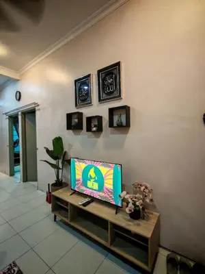 a living room with a flat screen tv on a wall at Homestay Sakinah No 39 in Tanjung Malim