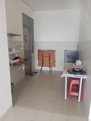 a kitchen with a table and a tiled floor at Little sweet in Gua Sai