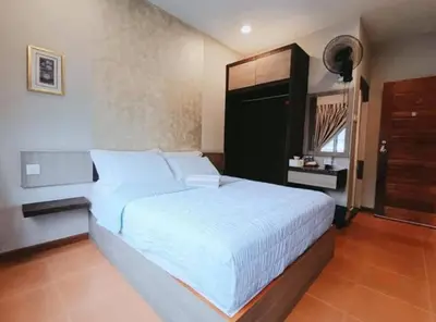 a bedroom with a large white bed in a room at Homestay Lung Tok in Bukit Mertajam