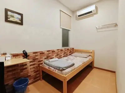 a small room with a bed in the corner at Homestay Lung Tok in Bukit Mertajam