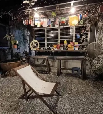 a chair sitting in a room with a table at Homestay Lung Tok in Bukit Mertajam