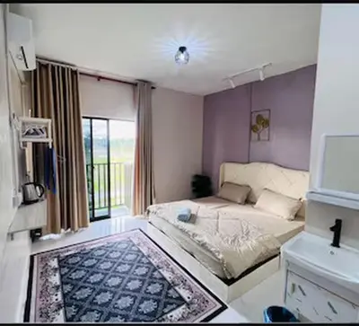 a small bedroom with a bed and a window at Capital O 91180 Mentari Senja Homestay in Kampong Dekeh