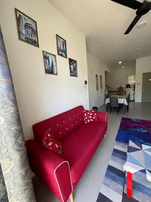 a red couch sitting in a living room at AYAAN Muslimah home at Golden Hill near Night Market in Brinchang