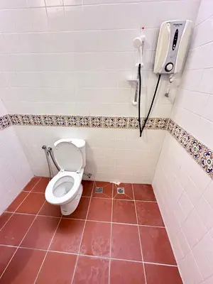 a bathroom with a toilet and a phone on the wall at Rangoon Residence 26 in George Town