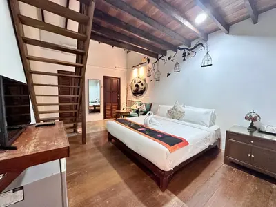 a bedroom with a large bed in a room at Rangoon Residence 26 in George Town