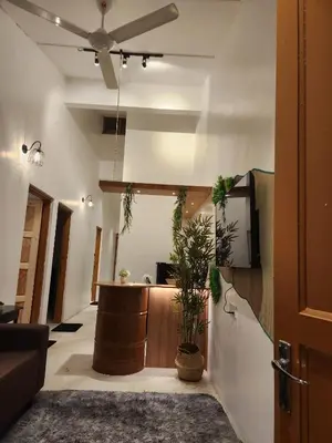 a lobby with a reception desk and potted plants at Sun Rimba Home by Ipoh Maju Stay in Ipoh
