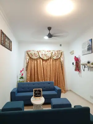 a living room with a blue couch and a window at Auliya Homestay in Gua Sai