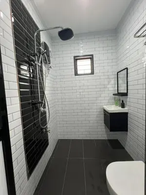 a bathroom with a shower and a toilet and a sink at Eiffel Villa Homestay Melaka in Gua Sai