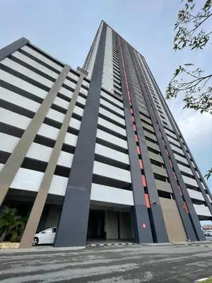 a tall building with a car parked in front of it at Wake Up Above The City Lights in Sitiawan