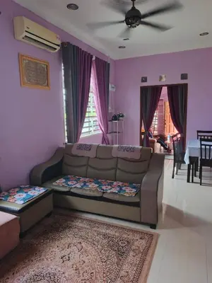 a living room with a couch and a table at Jannah Paddyview homestay
