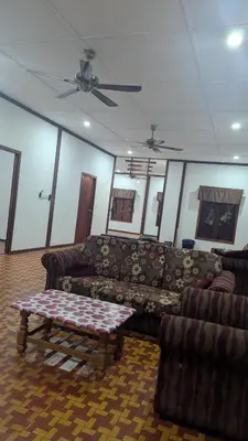 a living room with couches and a coffee table at Abadi's Homestay in Tanjung Karang