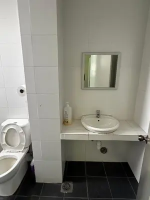 a bathroom with a sink and a toilet and a mirror at AYAAN MARIGOLD at Golden Hills Night Market View in Brinchang