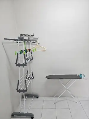 a room with a table and a rack with tools at Teratak Abah in Seri Manjung