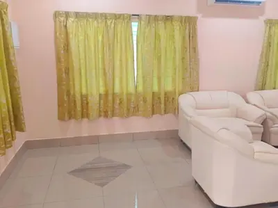 a living room with a couch and a window at Cream Roof Homestay in Gua Sai