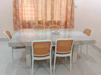a dining room table with four chairs and a window at Cream Roof Homestay in Gua Sai